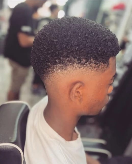 Capelli afro con sfumatura netta sui lati, vista di profilo